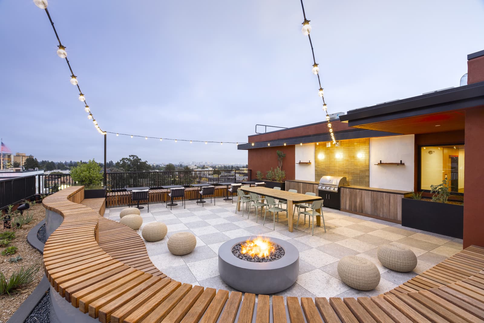 Rooftop lounge with fire pit and string lights
